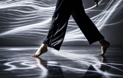 Close detail of a dancer moving across projection light lines